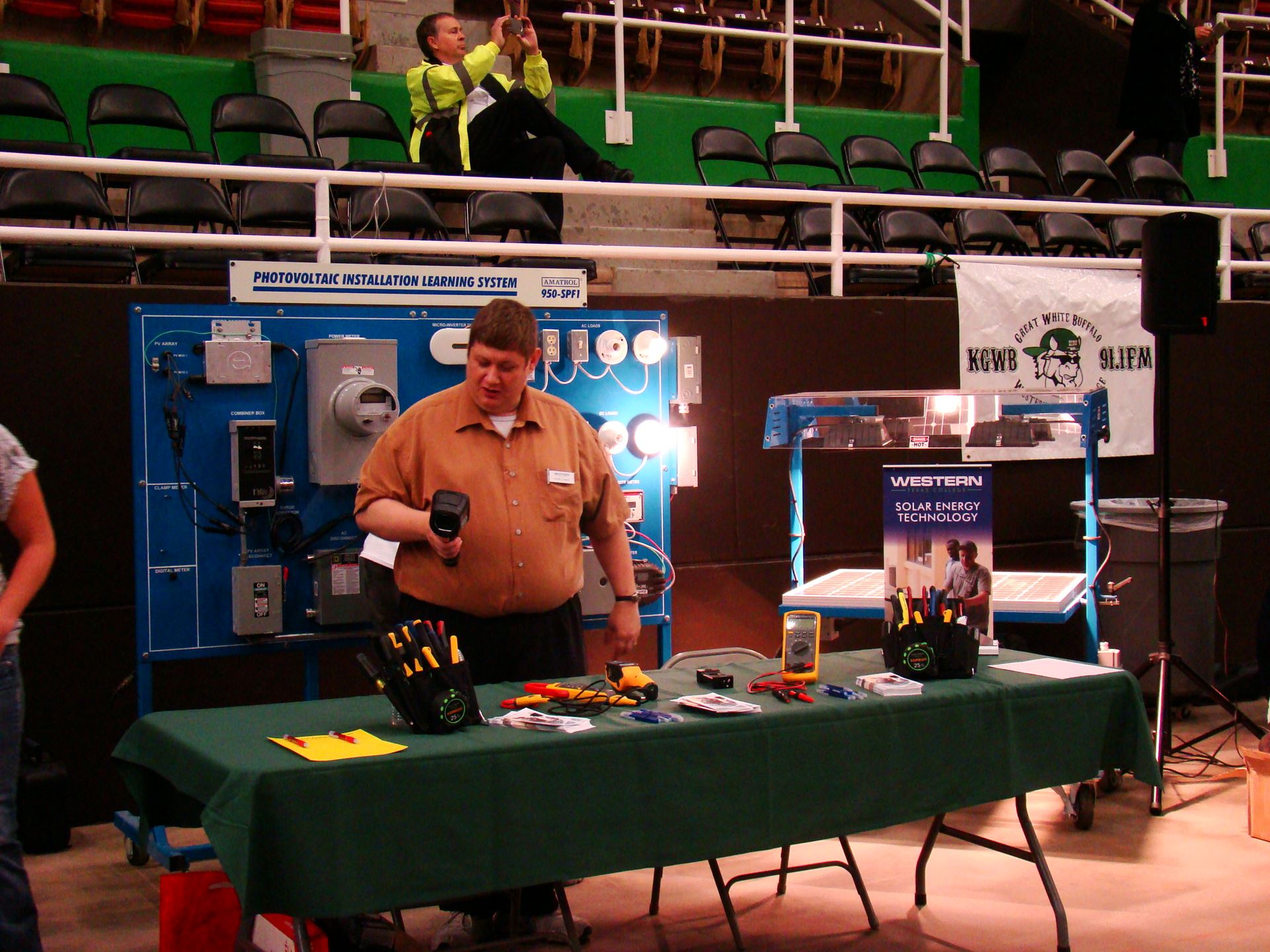 Individuals at solar energy booth.
